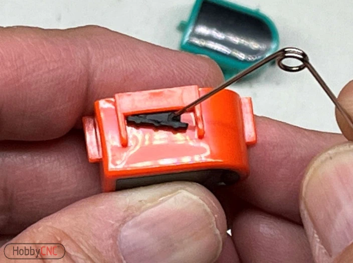 Showing removal of Guitar Hero fret button 'rubber bumpers'